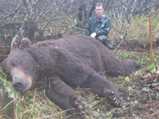 Hunter with a Brown Bear on the Alaska Peninsula