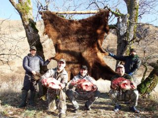 Hunters pictured with a Kodiak Brown Bear Skin